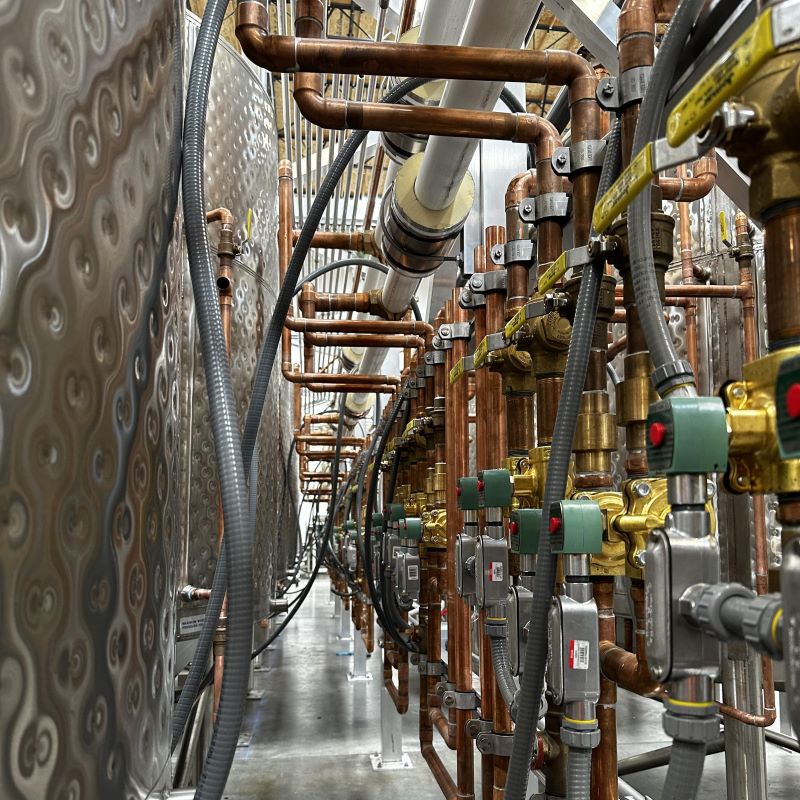 ASME B31.1 power piping installation for high-pressure industrial steam and condensate return lines.