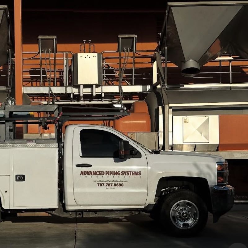 Advanced Piping Systems work truck at a commercial construction site for large-scale winery expansion bids in Sonoma County.